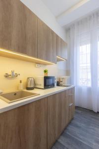 a kitchen with a sink and a microwave at TOP Location Studio at Deák Sqr in Budapest