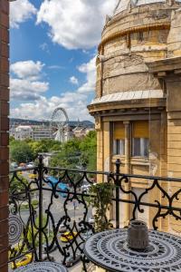 a table on a balcony with a view of a city at TOP Location Studio at Deák Sqr in Budapest