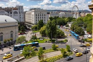 a city with buses and cars on a street at TOP Location Studio at Deák Sqr in Budapest