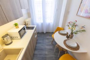 a small kitchen with a table and a microwave at TOP Location Studio at Deák Sqr in Budapest