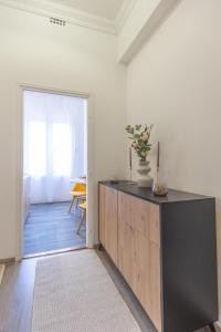 a room with a dresser with a vase on it at TOP Location Studio at Deák Sqr in Budapest