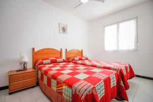 a bedroom with two beds and a window at Edificio Esmeralda in Peniscola +221 photos