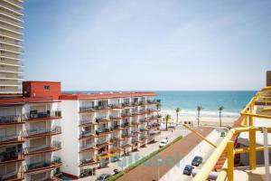 a view of the beach from the balcony of a building at Edificio Esmeralda in Peniscola