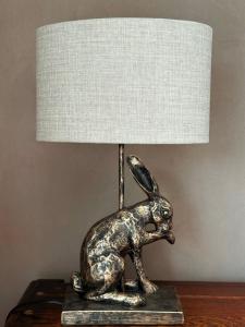 a bronze rabbit lamp sitting on a table at Moorlands in Bartley +20 photos