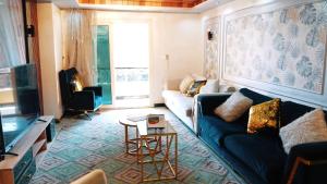 a living room with a couch and a table at Premium Swiss Residence Agouza in Cairo