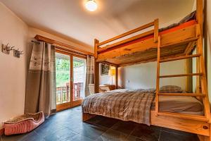 a bedroom with a bunk bed and a window at Le Cervin Rouge in Crans-Montana