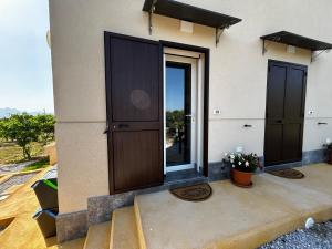 a house with a door and stairs to a balcony at Case Vacanze Villa Parisi in Bagheria