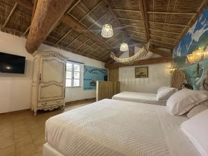 Ένα ή περισσότερα κρεβάτια σε δωμάτιο στο Studio Tahiti du Cloitre +8 φωτογραφίες