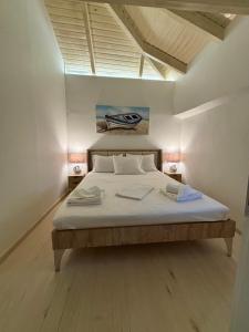 a bedroom with a bed in a room with a skylight at WoodHome in Kalamitsi