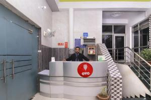 a man standing behind a counter in a building at HOTEL O JMD INN in Gomti Nagar