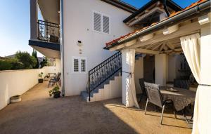 a patio of a house with a table and chairs at Apartment Rovanjska in Rovanjska +21 photos