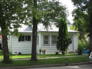 a white house with trees in front of it at Canora Vacation Home in Canora