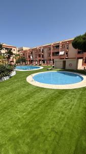 una imagen de dos piscinas en un patio en Enebrales Home, en Punta Umbría