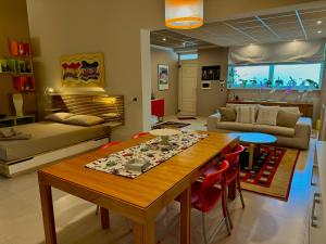 a living room with a table with chairs and a couch at Le More Apartment in Rutigliano