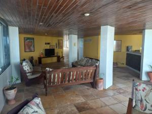 a living room with a couch and a wooden ceiling at Hotel e Restaurante Samburá in Olinda