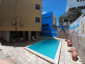 a large swimming pool next to a building at Hotel e Restaurante Samburá in Olinda