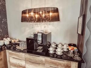 a table with a coffee maker and cups on it at Komm' In Hotel in Mechernich