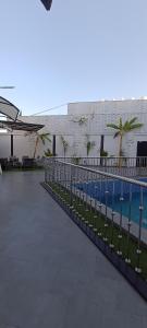a swimming pool with a fence next to a building at استراحة الشيوخ in Taif
