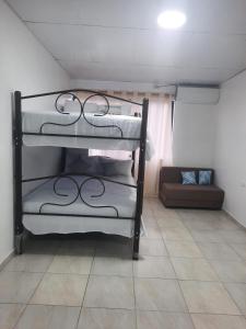 two bunk beds in a room with a couch at MiniSuite in Machala +4 photos