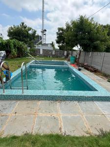 a small swimming pool in a yard with at Pooja Farmhouse in Hyderabad