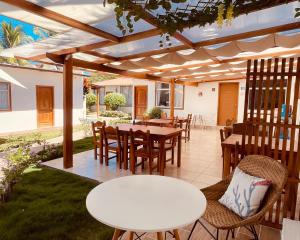 a patio with a white table and chairs at Hotel Coral Blanco with high speed internet Starlink and Galapagos Tour Operator in Puerto Villamil