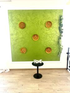 a painting of coins on a green wall at Pensiunea La Meleta in Şurdeşti
