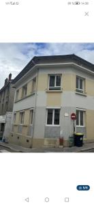 a white building with a stop sign in front of it at Le Palissy studio neuf et lumineux in Saint-Étienne