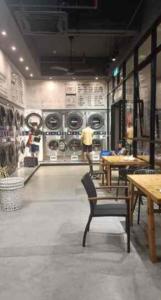 a room with a person in a room with washing machines at Sky Trees Nflix Make Up Table with Pool & Facilities in Johor Bahru