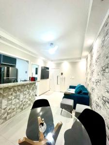 a living room with a glass table and chairs at Lindo estúdio frente à praia in Santos