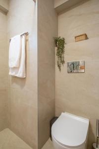 a bathroom with a toilet and a towel rack at The Serene Suite in Larnaka +15 photos