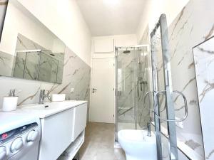 a bathroom with a shower and a sink at La casa di Mariposa in Sanremo +9 photos