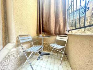 two chairs and a table in a window at La casa di Mariposa in Sanremo
