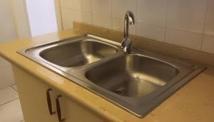 a stainless steel sink with a faucet in a kitchen at SWEET Apartment in San Giorgio Ionico +64 photos