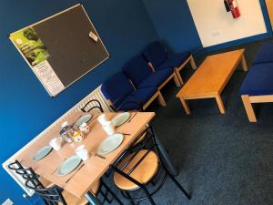 a classroom with a wooden table with chairs at Carrock Hall, University of Cumbria Carlisle in Carlisle