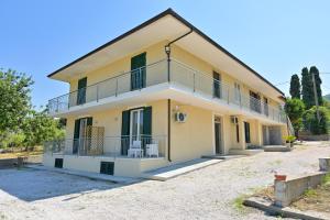 a large yellow house with a balcony at Villa Melina Bed & Breakfast in Agropoli