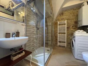 a bathroom with a sink and a shower at La Cripta - a due passi dalla Basilica - ItalyWeGo in Santa Maria degli Angeli +33 photos