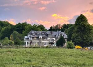 a large house on a hill with a field at Domaine de la Jasseix in Croze +62 photos