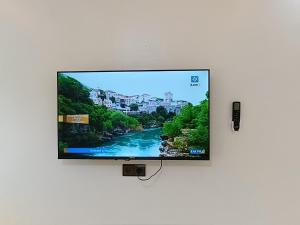 a flat screen tv hanging on a wall at Stay with dkouk 3 in Akchour