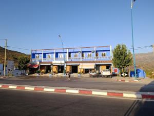 a large blue building on the side of a street at Stay with dkouk 3 in Akchour