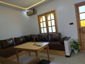 a living room with a couch and a table at Stay with dkouk 3 in Akchour
