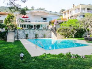 a house with a swimming pool in a yard at Villa Büyükada I Private Pier & Seawater Pool in Istanbul +32 photos