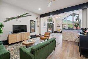 a living room with a couch and a tv at Lift House Lodge, Boutique Premium Studio Condo in Vail