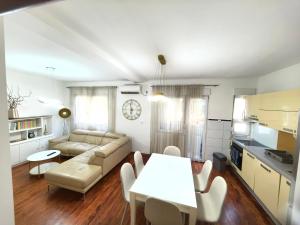 a living room with a couch and a table at Luxury apartment Podgorica in Podgorica