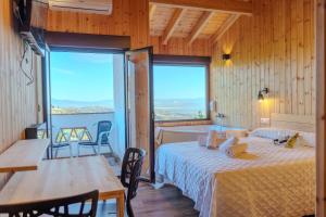 a room with two beds and a table and chairs at La Luna del sur B&B in Granada
