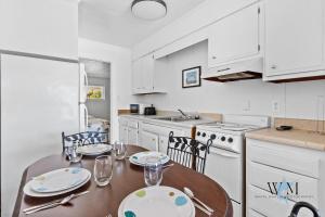 a kitchen with a table with plates and glasses on it at 2 Bed1 Bath on the Boardwalk by the Inlet in Ocean City