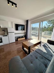 a living room with a couch and a table at Villa & Apartament Armonia 3 Gaia Flora GRECJA KRETA in Vamos +68 photos