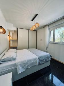 a bedroom with a bed and two chandeliers at Villa & Apartament Armonia 3 Gaia Flora GRECJA KRETA in Vamos