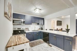 a kitchen with blue cabinets and a white counter top at Updated North Greenwood Cottage Less Than 1 Mi to Dtwn! in Greenwood