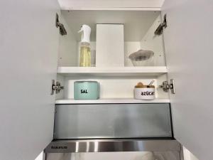 a small kitchen with a sink and shelves at Apartamento Centroplaya in Bueu