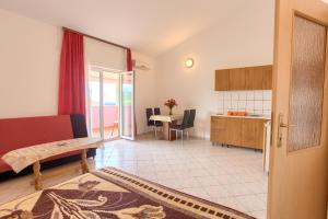 a living room with a kitchen and a dining room at Ranka1 Krk in Kornić